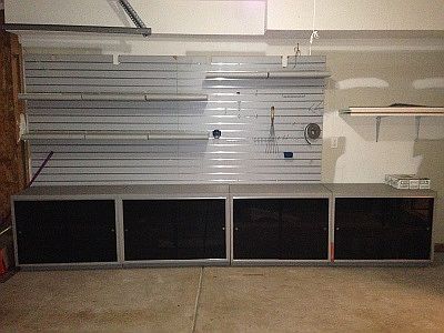 2-car garage with built in cabinets and shelves for storage