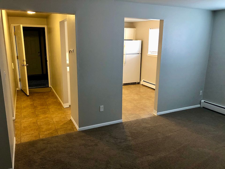 Living area looking at door and kitchen