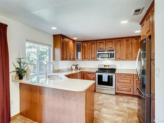 Beautiful Kitchen with Tile, Stainless Steel Appliances and Quartz Counter Tops.
