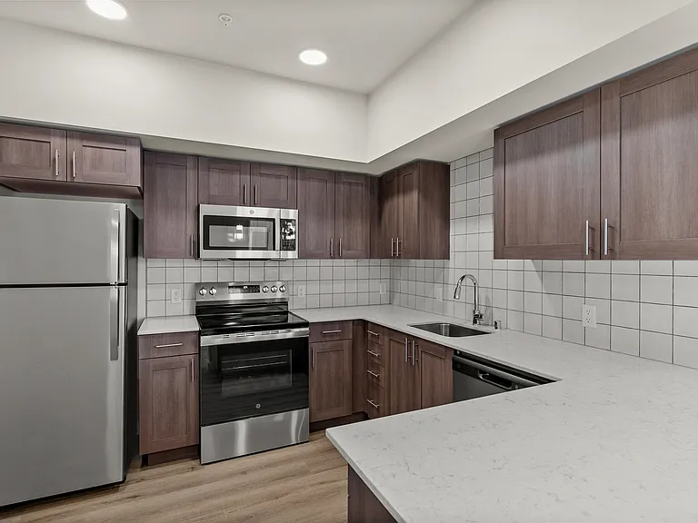 Enjoy cooking in a fully equipped kitchen with sleek stainless steel appliances and generous counter space. Enjoy cooking in a fully equipped kitchen with sleek stainless steel appliances and generous counter space.
