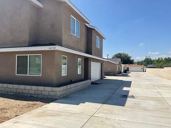 there is 4 houses front house has garage and additional parking