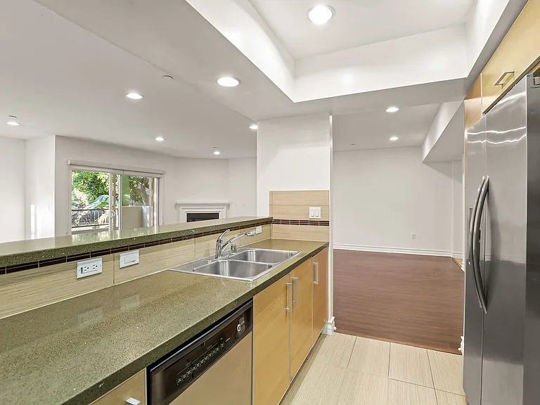 Kitchen and Living Room Area with Electric Fireplace and Patio