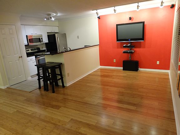 open floor plan with granite, stainless, and hardwood floors