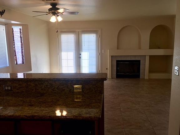 From kitchen breakfast bar, looking into family room with fireplace