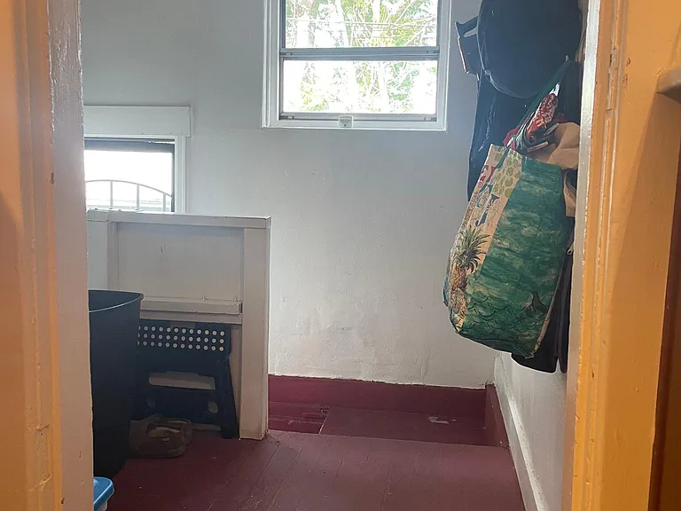 Stairs to the basement from the kitchen. Door to 2 parking spaces in the back of the house and Tuff Shed.