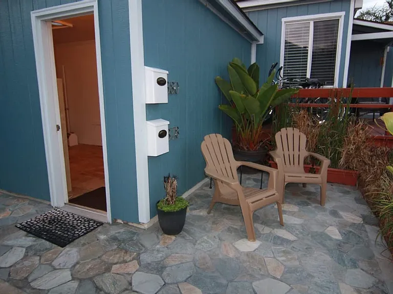 Front door to the studio with a sitting area out front