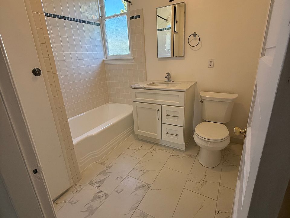 New, fresh, clean bathroom ! Tile floors, vanity, toilet, shower over tub , floor to ceiling cabinets.