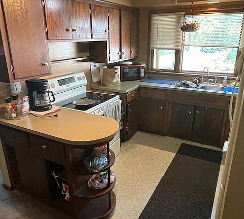 Wrap around kitchen with overhead lighting. Generous cabinet space.
