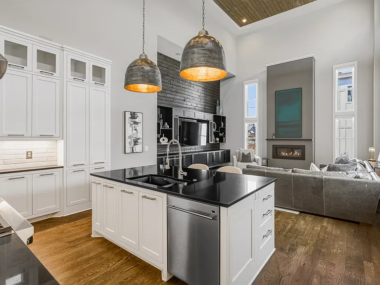 The chef's kitchen boasts a massive island, pantry wall, Wolf steam & convection ovens, a 6-burner 36" gas range and Sub-Zero refrigerator. Everything you need to cook at home, plus island seating and a dining table/room.