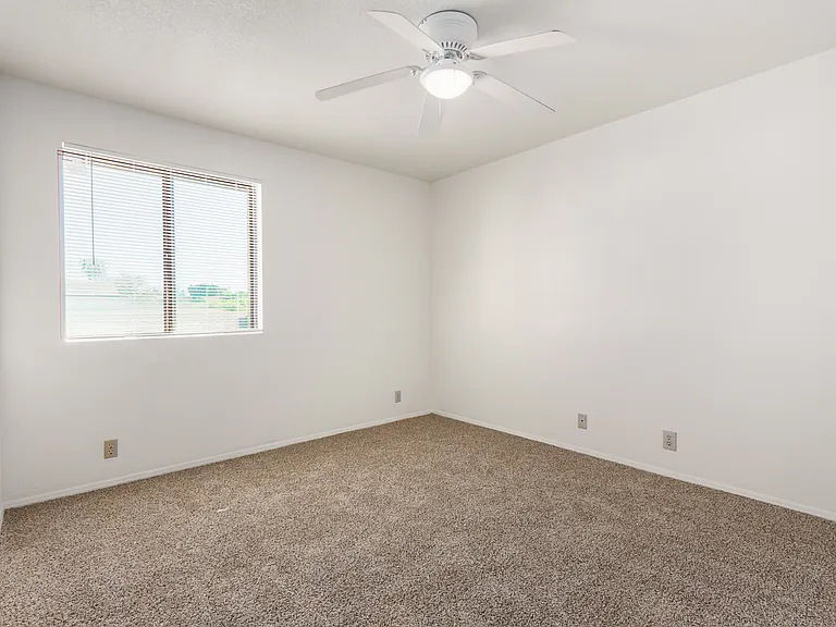 View of upstairs bedroom #2. New paint, flooring, and mirrored closet doors.