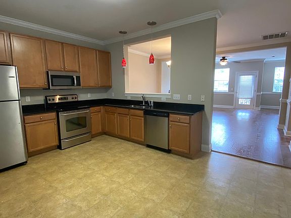Open floor plan, the kitchen leads into a dining area and family room.