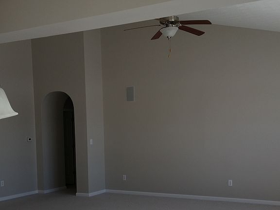 Great room with cathedral ceiling with expansive windows ove