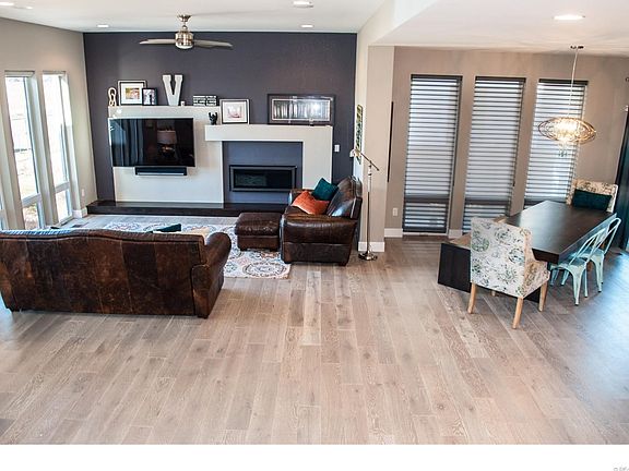Upgraded Flooring. Heat-N-Glo Horizontal Fireplace. Ceiling fan. Designer Chandelier.  Hunter Douglas Shades