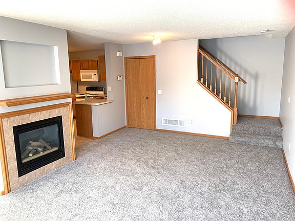 Living room with fireplace. Freshly painted and new carpet throughout
