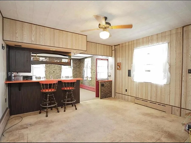 Big windows in this large, centrally located dining room, with a breakfast bar and access to that great raised deck!
