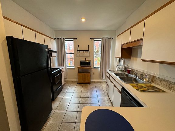 kitchen with excellent appliances and sit in bar with stools