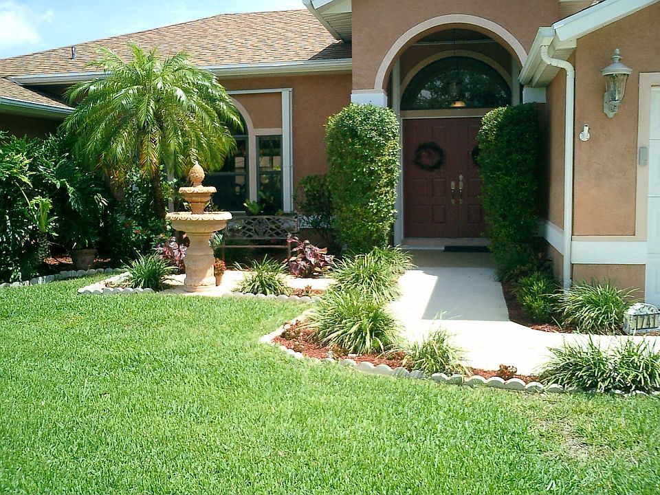 View of entry and fountain w/garden