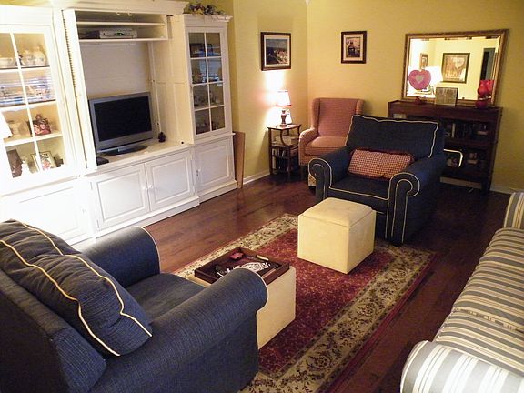 Large living room with beautiful hardwood floors and crown moulding.