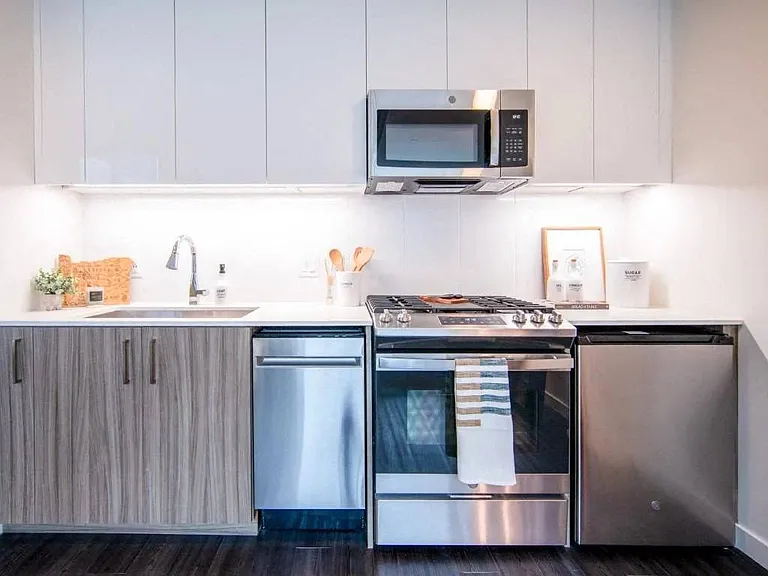 Cook like a pro with natural gas ranges, built-in microwave, and slow-close walnut cabinetry