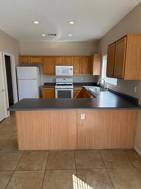 Kitchen with wrap around breakfast bar - 13029 W Windrose Dr