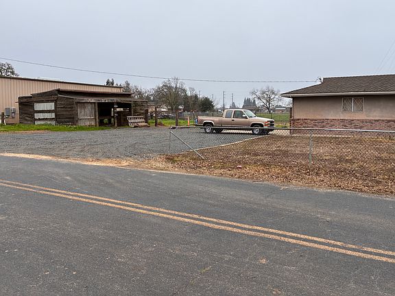 Parking area with small barn