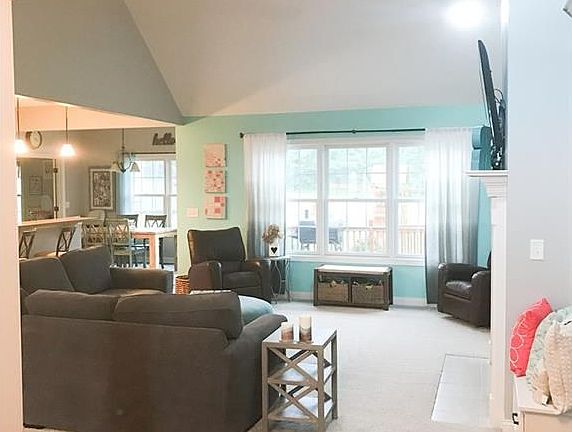 View from the entry way to the vaulted ceiling living room