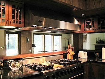 The Viking hood over the six burner gas range and a view from the kitchen looking into the living room.  