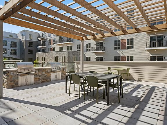 Outdoor courtyard with grilling and dining area.