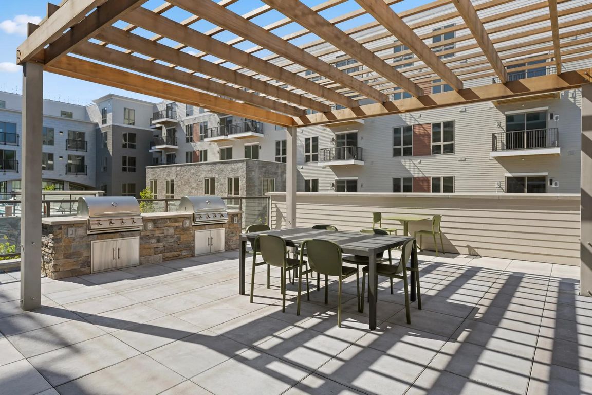 Outdoor courtyard with grilling and dining area.