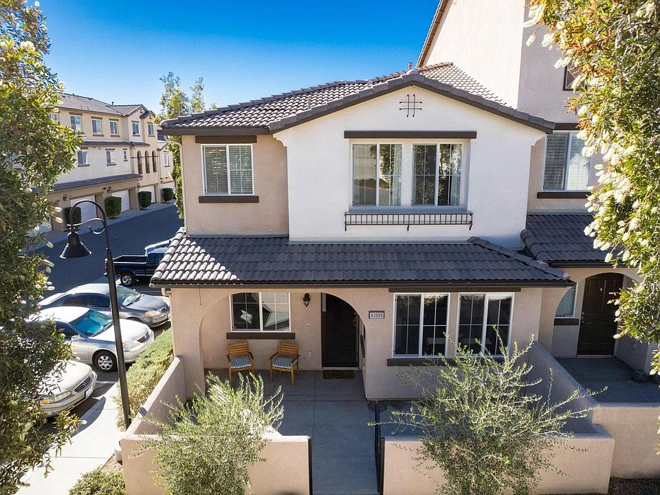 Front of property. Note the large patio and view of trees and landscaped area.