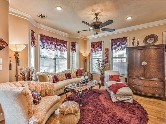 Living room features crown molding and hardwood floors which continue throughout the home.