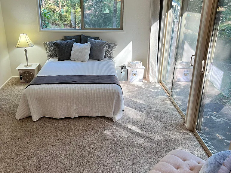 24' x 11' main bedroom suite has forest views and rhododendrons in bloom.