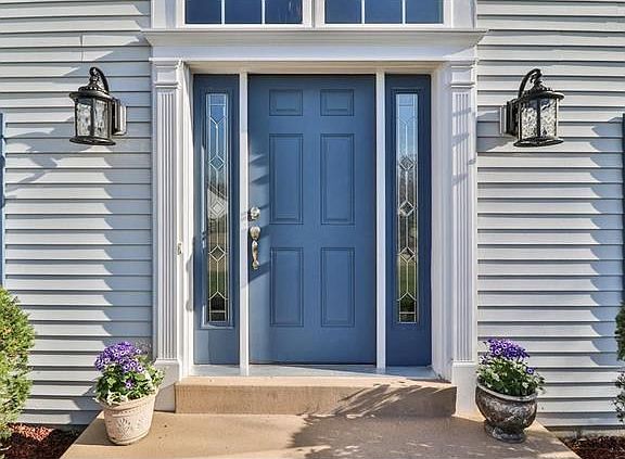 Notice the recent upgraded door surround with crosshead and fluted balustrade accents.  Leaded Glass side lights frame the Entry and a large Arched Window is the crowning touch.  New coach Lamps offer the perfect greeting for your guests.