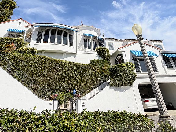 Covered parking spot next to white car