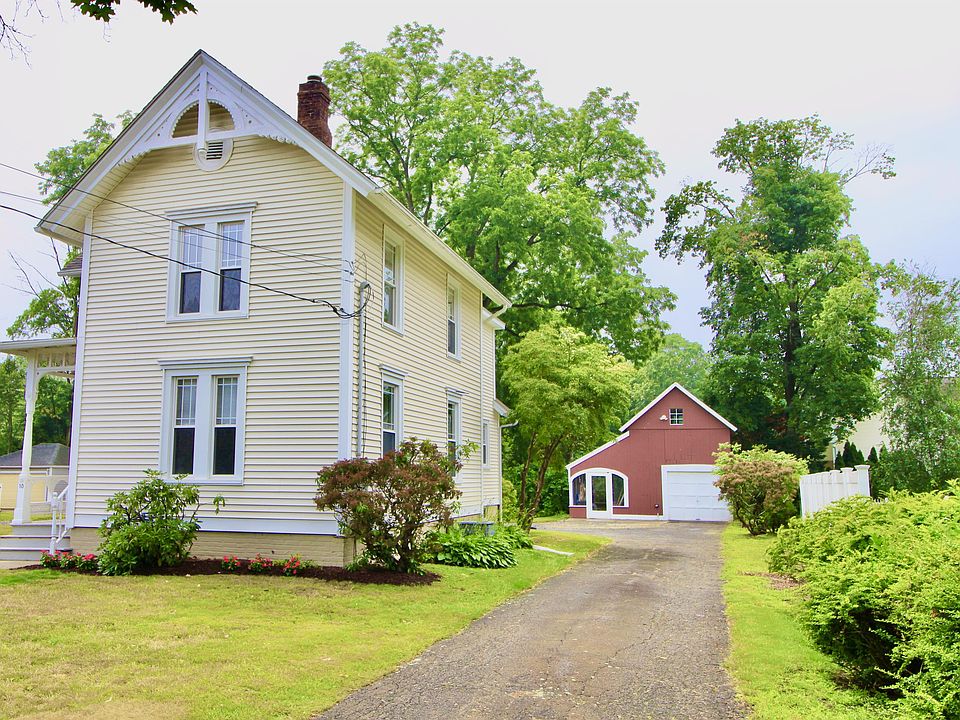 Front street view- covered porch on left side- barn//garage with screened in porch.