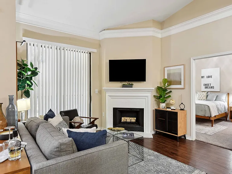 1-, 2-, and 3-bedroom apartments with spacious living room with fireplace and wood-style plank flooring.