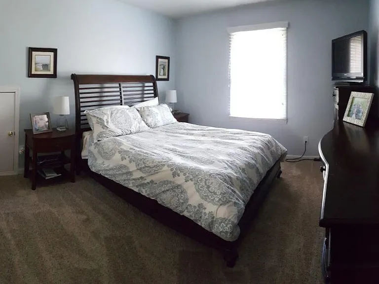 Master Bedroom. That little door? Opens to large storage area above 1.5 stall garage! Garages in this neighborhood are a rare find.