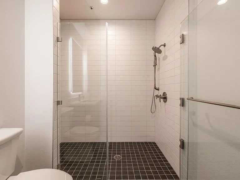 Bathroom with walk-in shower in a 1400 FIG Live and Work Apartment at 1400 S. Figueroa St., Los Angeles, CA 90015.