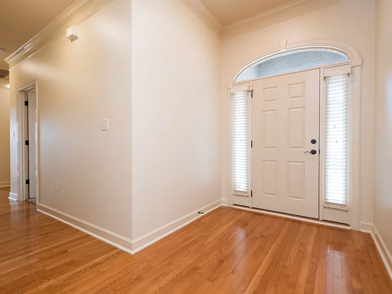Front door and hallway to the shared full bath with both bedrooms. Then you have the garage and laundry at the end of the hallway.