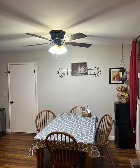 Dining room with door out to the garage, and on the right, there is a dual-pane sliding door to a small deck.