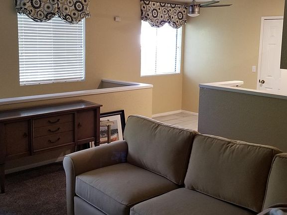 Living room with kitchen nook in the back ground.