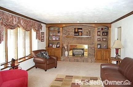 Great Room : Gas fireplace, large bay window, wood trim.