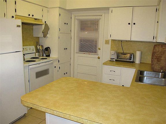 Wonderful kitchen offers abundant cabinetry & counter space, large breakfast bar, and updated dishwasher!  Opens to the lovely dining area and the supersized family room!