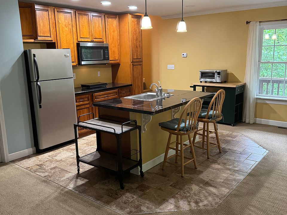 Kitchen area set up with high top chairs and all items as seen.
