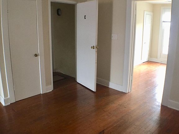 Living room showing front door and entry into front bedroom