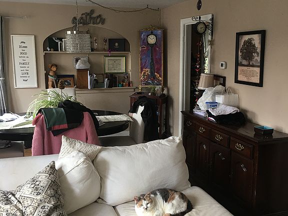 Large living room with south facing windows and built in shelves.