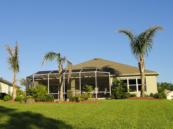 Back of home with 22x28 foot screened lanai - on golf course
