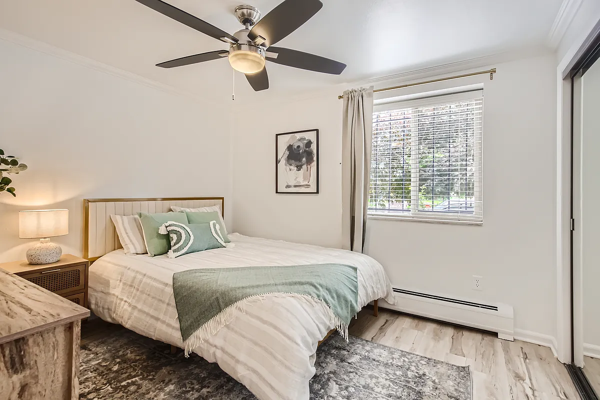 The primary bedroom features a brand-new queen size mattress with soft sheets and pillows, a nightstand and reading lamp, a ceiling fan, blackout curtains, and a dresser plus a large closet for storing all of your clothes and gear. - 1135 Elizabeth St #101