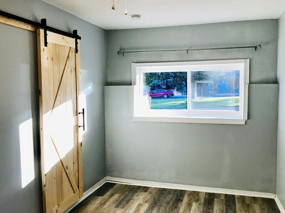 Tons of afternoon light in the master bedroom with custom sliding barn door. Fully renovated in 2018.