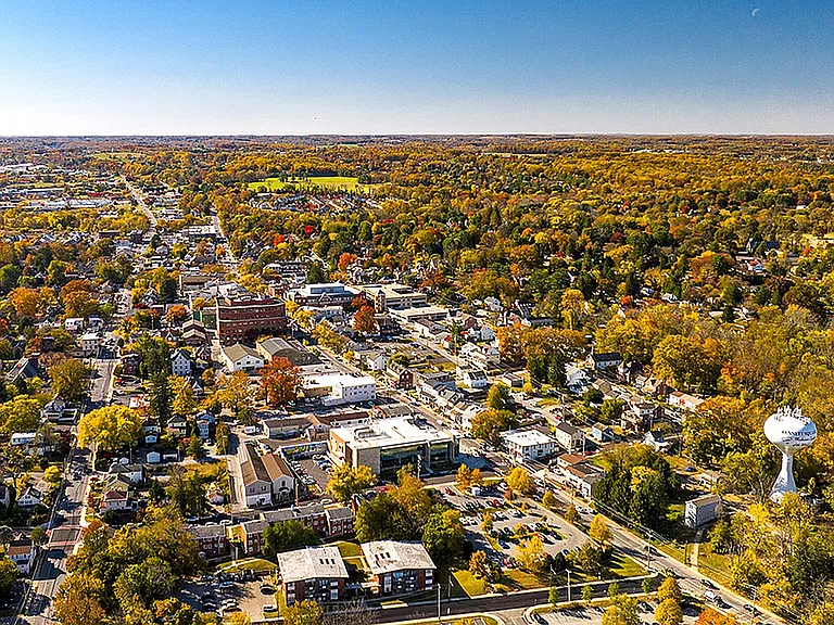 Explore the charm of this vibrant town nestled in a scenic autumn landscape.